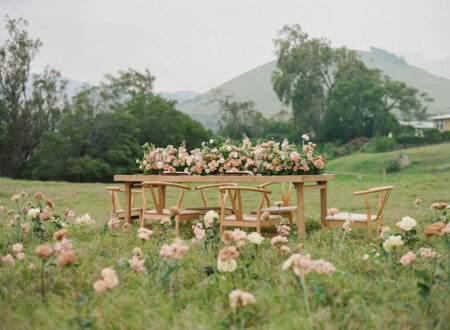 Floralscape on a reception table in front of a historic home at Parker Ranch